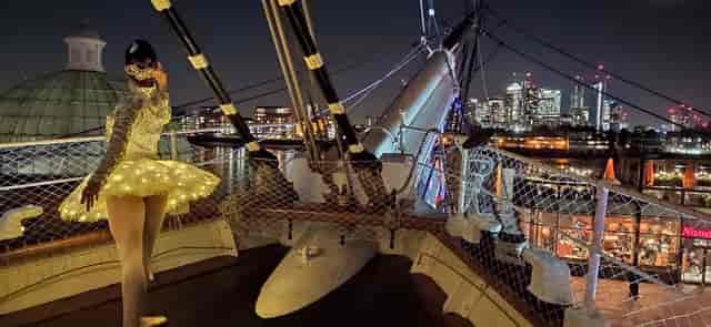 Illuminated performer on The Weather Deck, Cutty Sark, ideal for corporate events.