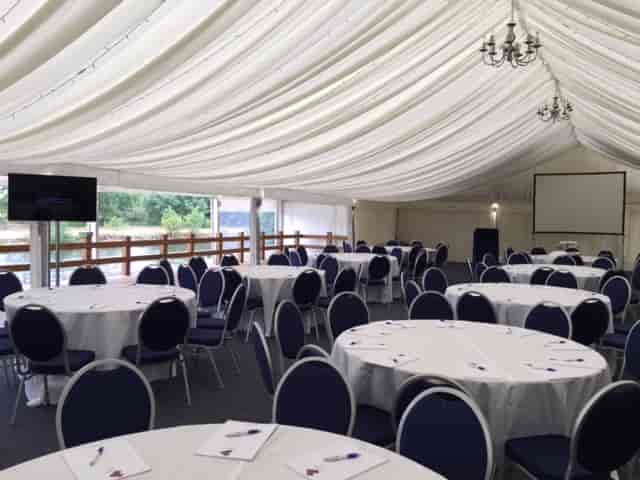 Elegant event space with round tables, ideal for corporate meetings or banquets.