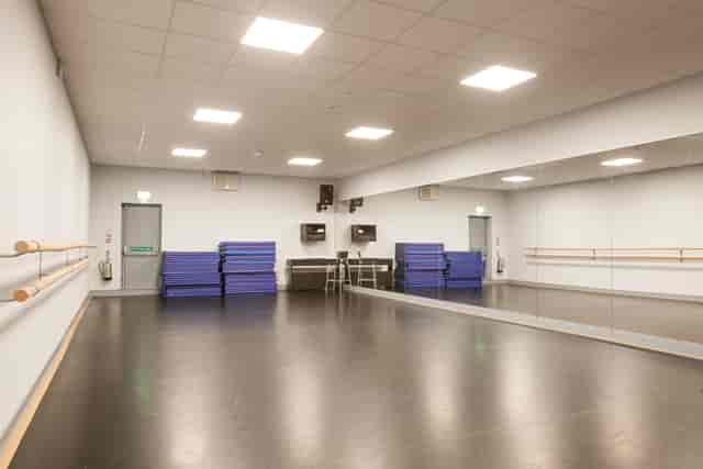 Versatile dance studio with mirrored wall, perfect for workshops and group sessions.