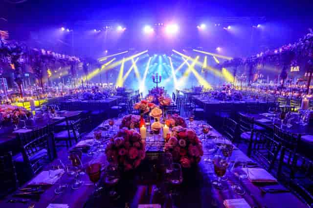 Elegant event setup at The Cotton Sheds, featuring floral centerpieces and ambient lighting.