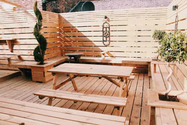Versatile outdoor venue with wooden seating for casual meetings and networking events.