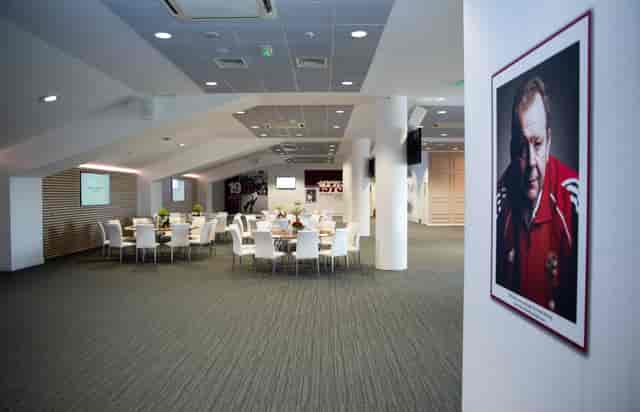 Modern event space with round tables at Allianz Stadium, ideal for corporate meetings.