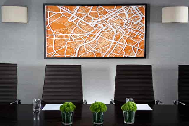 Modern boardroom at Hyatt Regency Birmingham with stylish chairs and vibrant artwork.