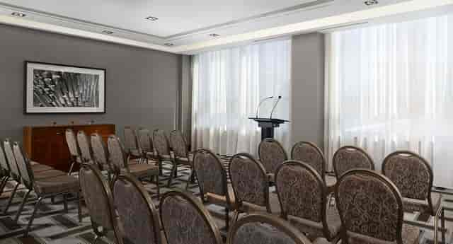 Soprano meeting room at Hyatt Regency Birmingham, elegant chairs for corporate presentations.