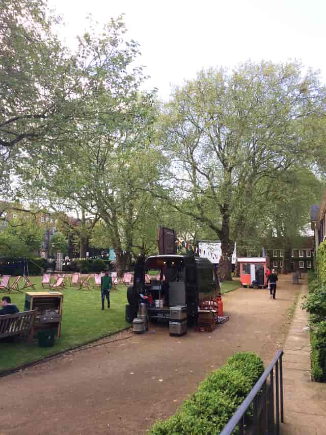 Vibrant outdoor event space at The Museum of the Home with lush greenery and food truck.