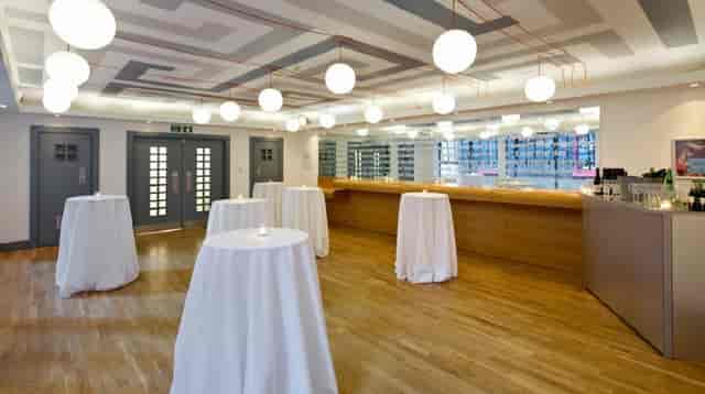 Elegant event space in Whitechapel Gallery with high-top tables for networking and receptions.