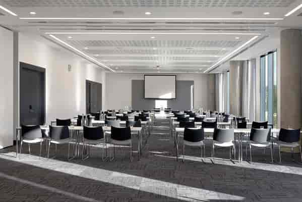 Modern classroom-style event space at INNSIDE Manchester for corporate training and presentations.