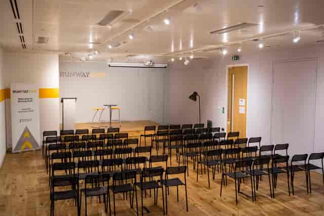 The Engine Room event space: modern theater-style setup for professional panel discussions.