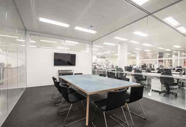 Modern glass breakout room at Howard Hughes, ideal for office meetings and corporate huddles.