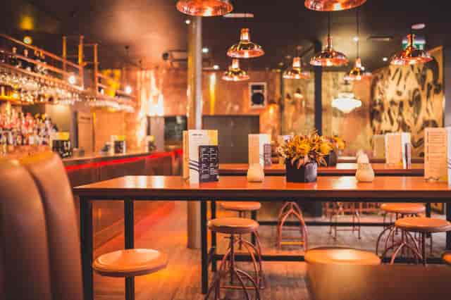 Stylish venue with warm lighting, perfect for intimate gatherings and networking events.