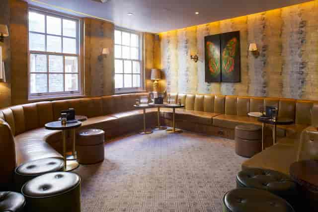 Stylish leather seating in intimate meeting space at Hush Mayfair for gatherings.