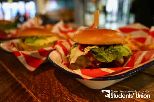 Gourmet burgers and fries in vibrant setup at Drapers Bar & Kitchen for networking events.