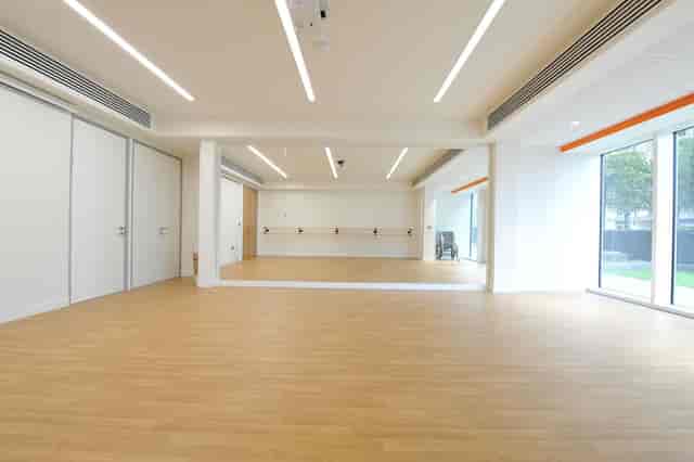 Muir-Warden Studio: bright event space with large mirror for workshops and fitness classes.