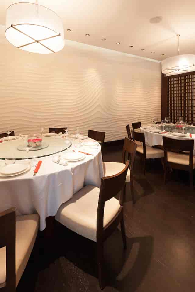 Private dining room with round table, ideal for intimate meetings and events.