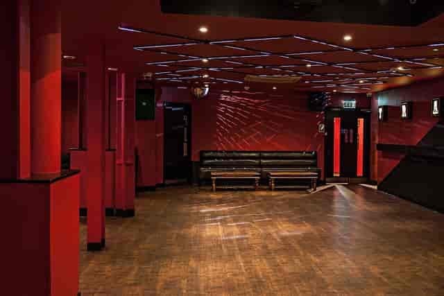 Modern event space with red walls, ideal for networking and parties at The Basement Club.