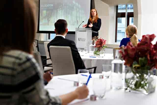 Professional meeting in modern conference room at 30 Euston Square, engaging speaker.