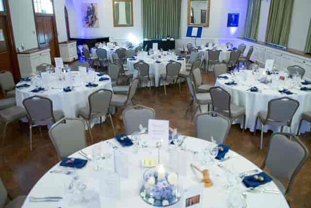London House Large Common Room set for a formal dinner with elegant table settings.