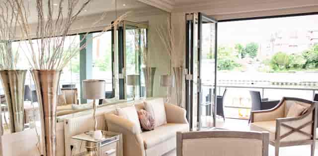 Modern event space with large windows at Ravens Ait Island for networking and gatherings.