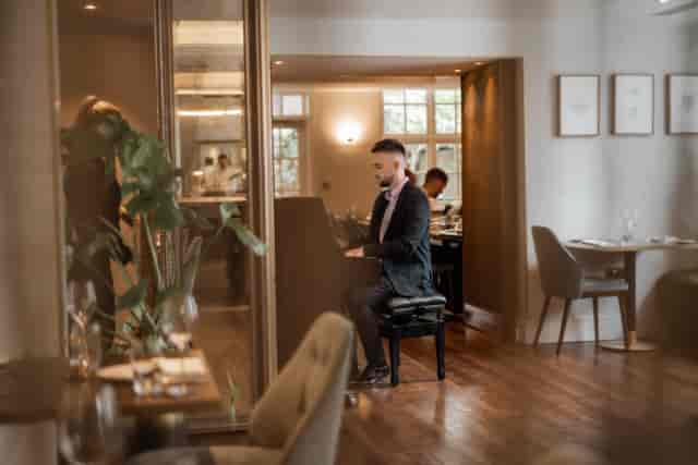 Elegant dining in The Roseate's Reading Room with live piano for upscale events.