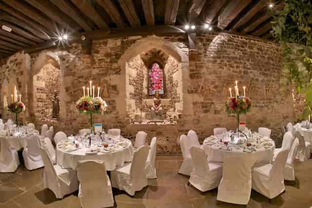 Elegant dining area in The Crypt with floral centerpieces, perfect for weddings and gala dinners.