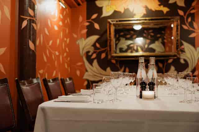 Elegant dining table in Bleeding Heart, perfect for intimate gatherings and corporate dinners.