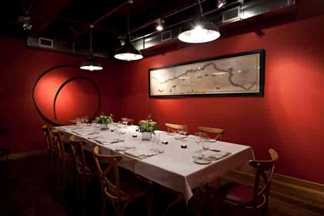 Private dining room with red walls for corporate board dinners and executive meetings.