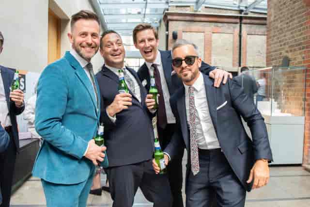 Lively networking event in The Goldsmiths' Centre Atrium, showcasing stylish attire and connections.