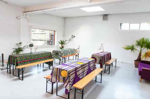 Spacious venue with vibrant tables, perfect for workshops and gatherings.