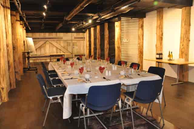 Elegant meeting space with rustic beams, perfect for corporate dinners and workshops.