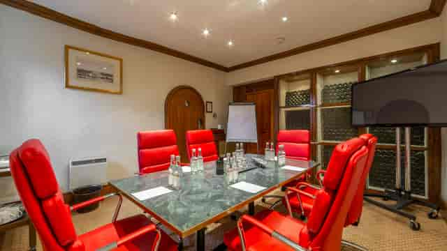 Small Study at Petersham Hotel with modern table and red chairs for meetings and workshops.