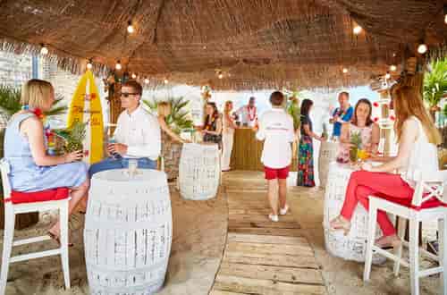 Beach Bar at The Montague: vibrant thatched roof venue for summer events and networking.