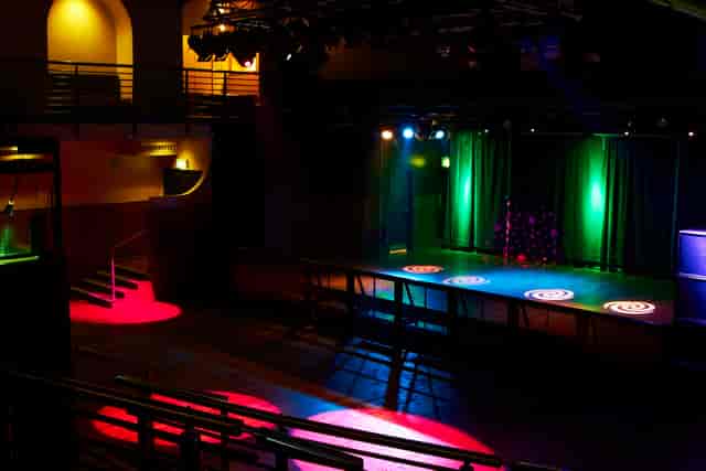 Versatile Scala venue with colorful stage lighting for corporate and social events.