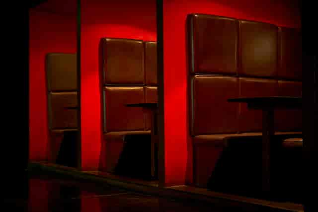 Modern booth with brown leather seating in Scala venue for networking events.