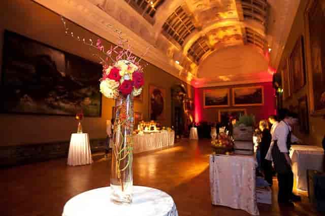 Elegant event space in Tate Britain with floral centerpieces for a gala or cocktail reception.
