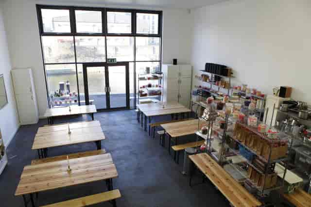 Versatile workshop space with wooden tables and natural light for events at Regent's Canal.