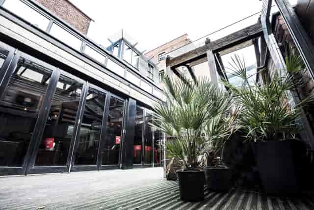 Versatile event space with large windows at Brickhouse Social for corporate and social gatherings.