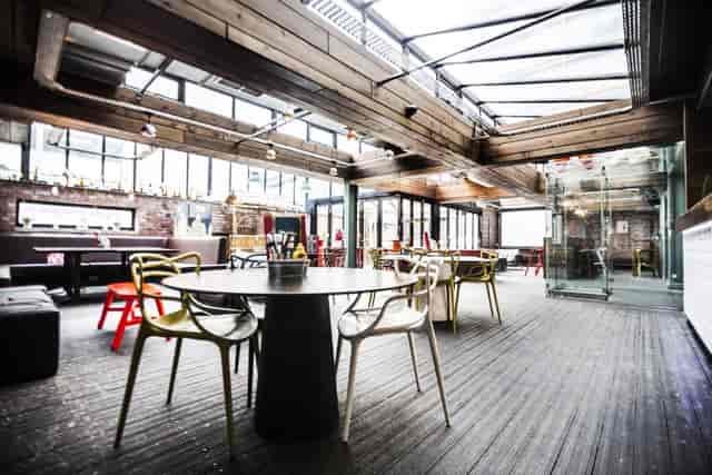 Modern event space at Brickhouse Social with bright windows, ideal for networking and meetings.