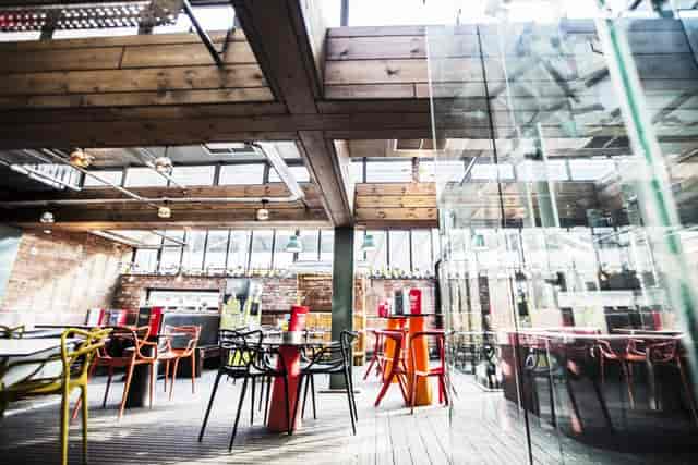 Modern event space with natural light and colorful seating at Brickhouse Social.