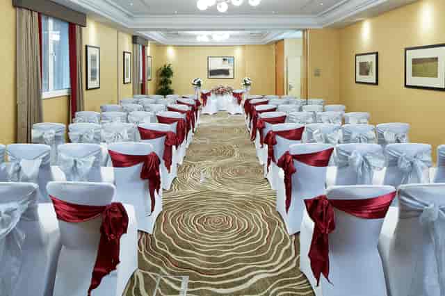 Queens Suite event space with elegant chairs, ideal for corporate meetings and gatherings.