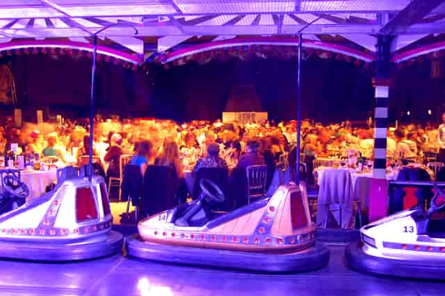 Vibrant event space in MAGNA with dining area and bumper cars for unique gatherings.