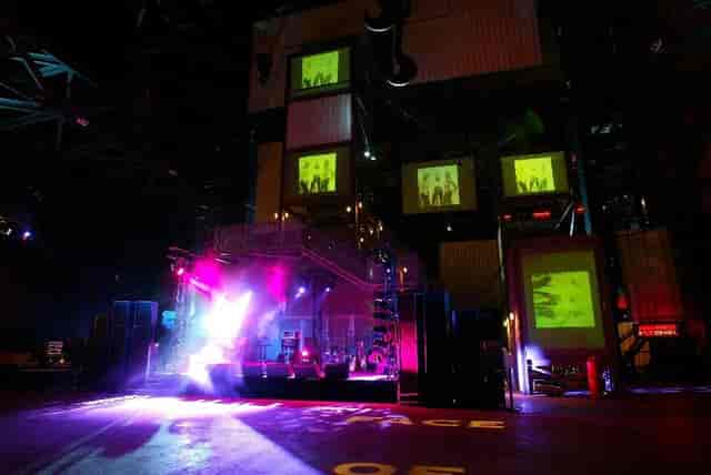 Dynamic event space with elevated stage, ideal for concerts and corporate gatherings.