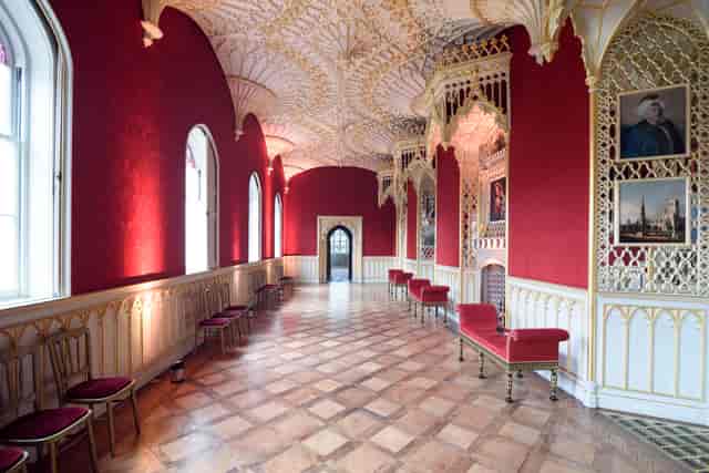 Ornate wedding venue with red walls and elegant seating at Strawberry Hill House.