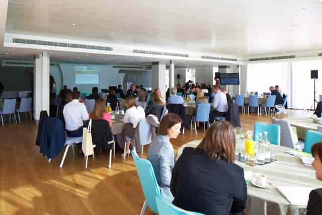 Thames View Suite conference with attendees, modern decor, networking and learning event.
