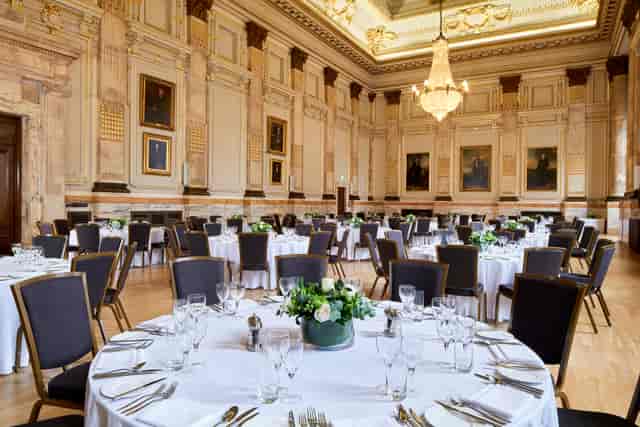 Elegant banquet hall with round tables, ideal for corporate events and upscale celebrations.