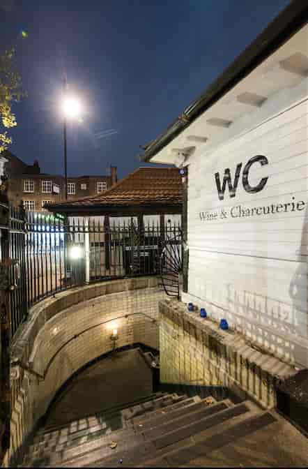 Wine bar entrance with warm lighting, ideal for intimate gatherings and networking events.