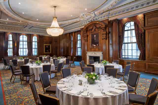Elegant ballroom event, round tables, opulent decor, awards ceremony, corporate gala