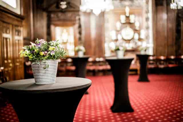 Elegant Livery Hall with high-top tables, ideal for networking events and cocktail receptions.