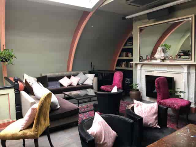 Le Salon Rose networking event, cozy fireplace.