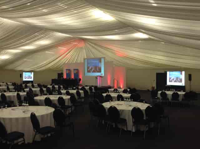 Clive Emson Conference Hall with round tables, ideal for corporate events and conferences.