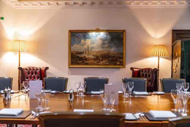 Executive dining room: polished wood table, client dinner, board meeting